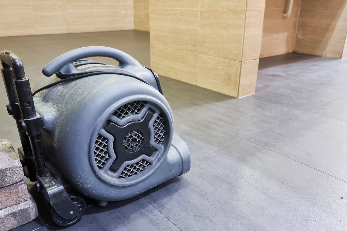 Professional water damage restoration and drying equipment in a home